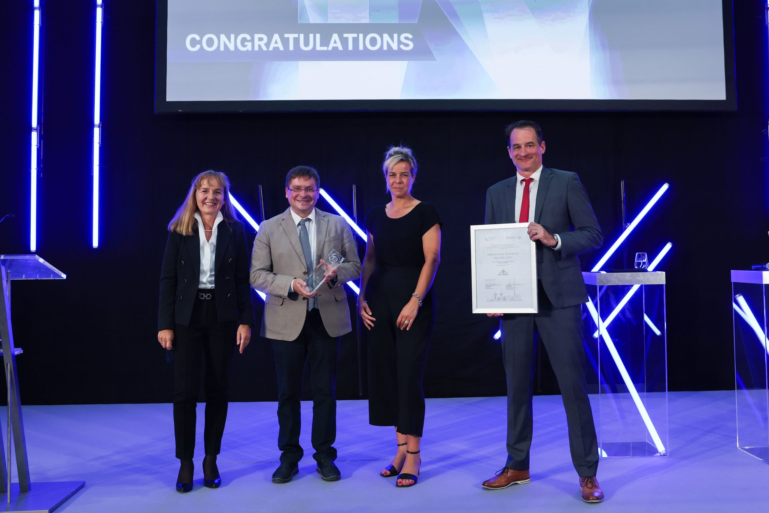Skyrora team member Olexandr Grydin receiving award from Ms. Mona Neuba, Mr. Felix Neugart and Ms. Petra Pigerl-Radtke.